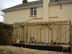 A timber-framed extension in progress